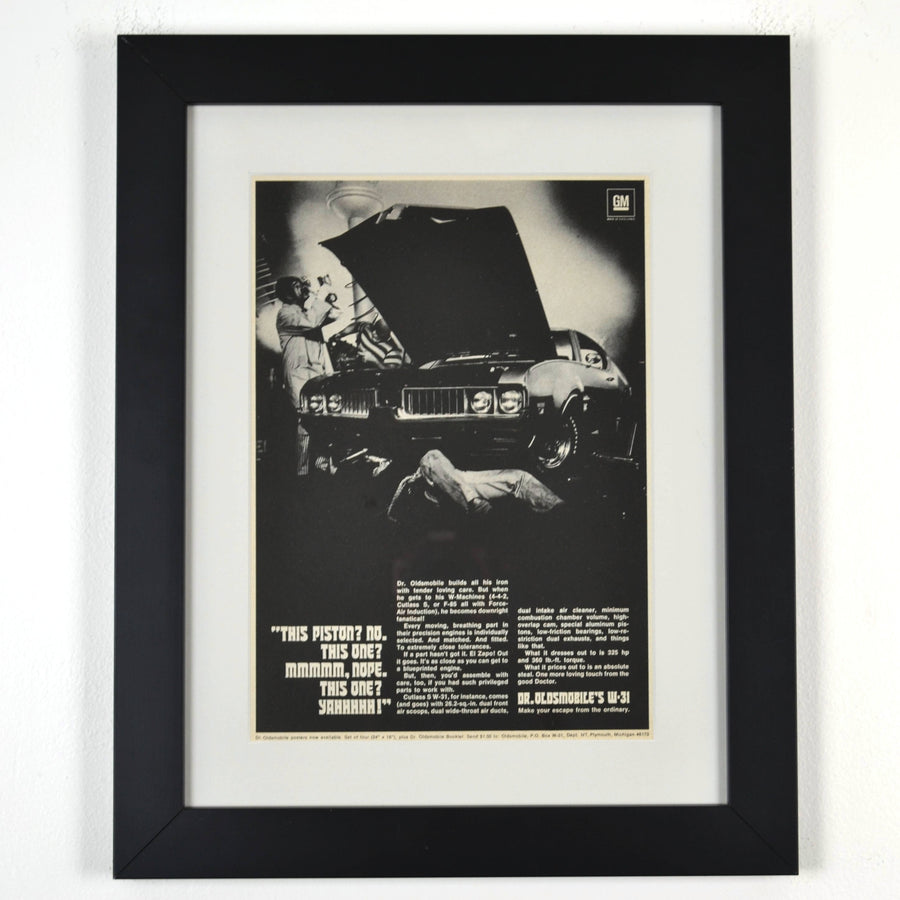 Framed 1969 Oldsmobile W-31 ad print with Dr. Oldsmobile inspecting pistons – 12x15 vintage car wall art

