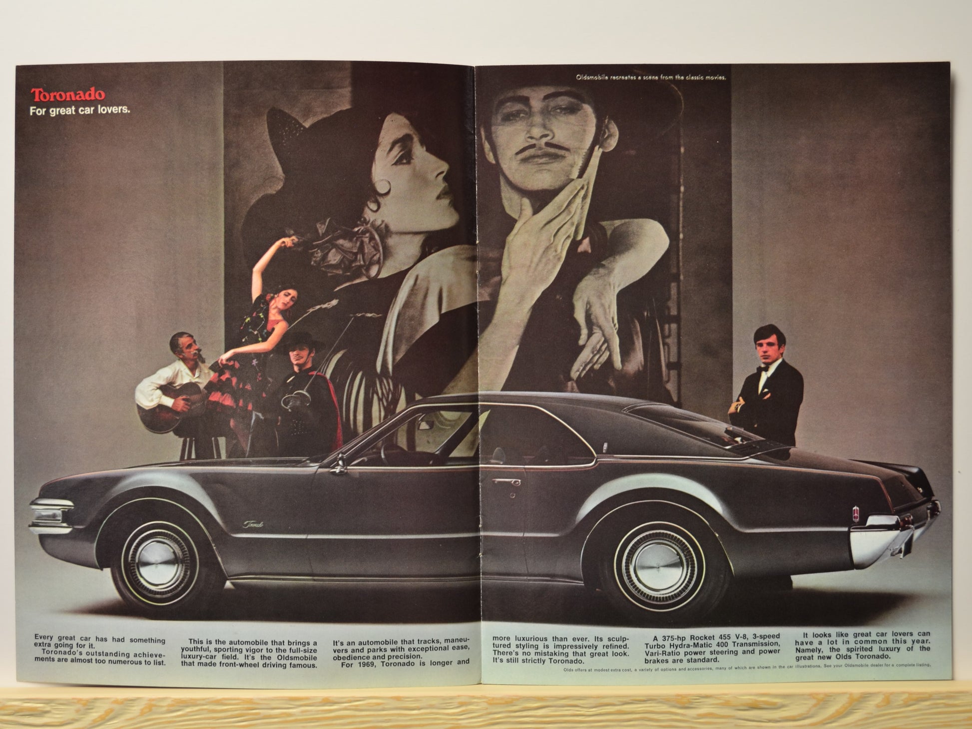 1969 Toronado side profile with flamenco scene and promotional text