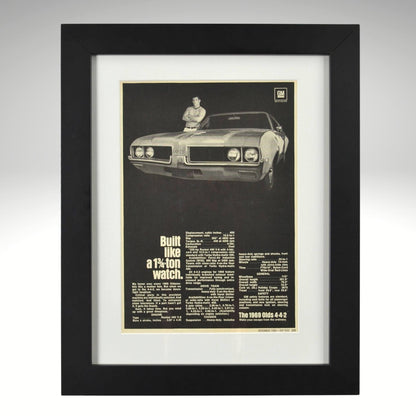 Framed 1969 Oldsmobile 442 print ad – black-and-white vintage muscle car ad with specs and bold type.