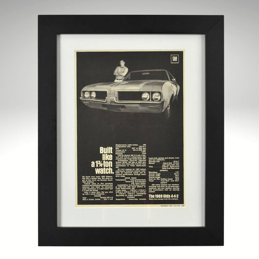 Framed 1969 Oldsmobile 442 print ad – black-and-white vintage muscle car ad with specs and bold type.