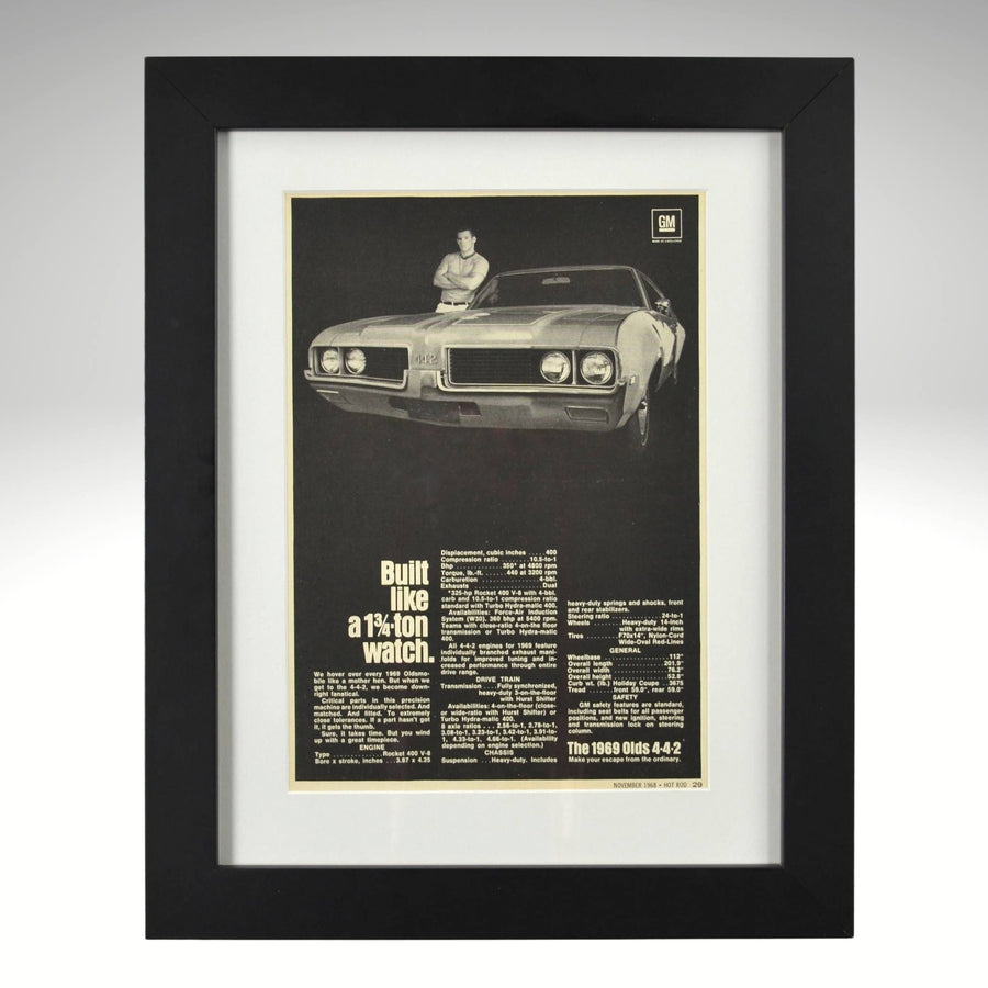 Framed 1969 Oldsmobile 442 print ad – black-and-white vintage muscle car ad with specs and bold type.