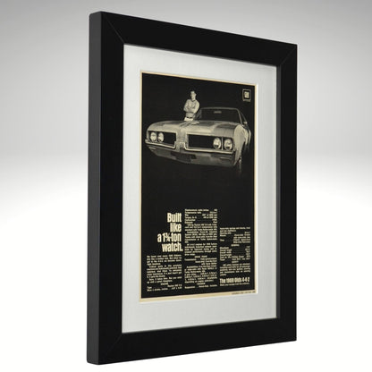 Framed artwork of a 1969 Oldsmobile 442 classic car with text on a white background
