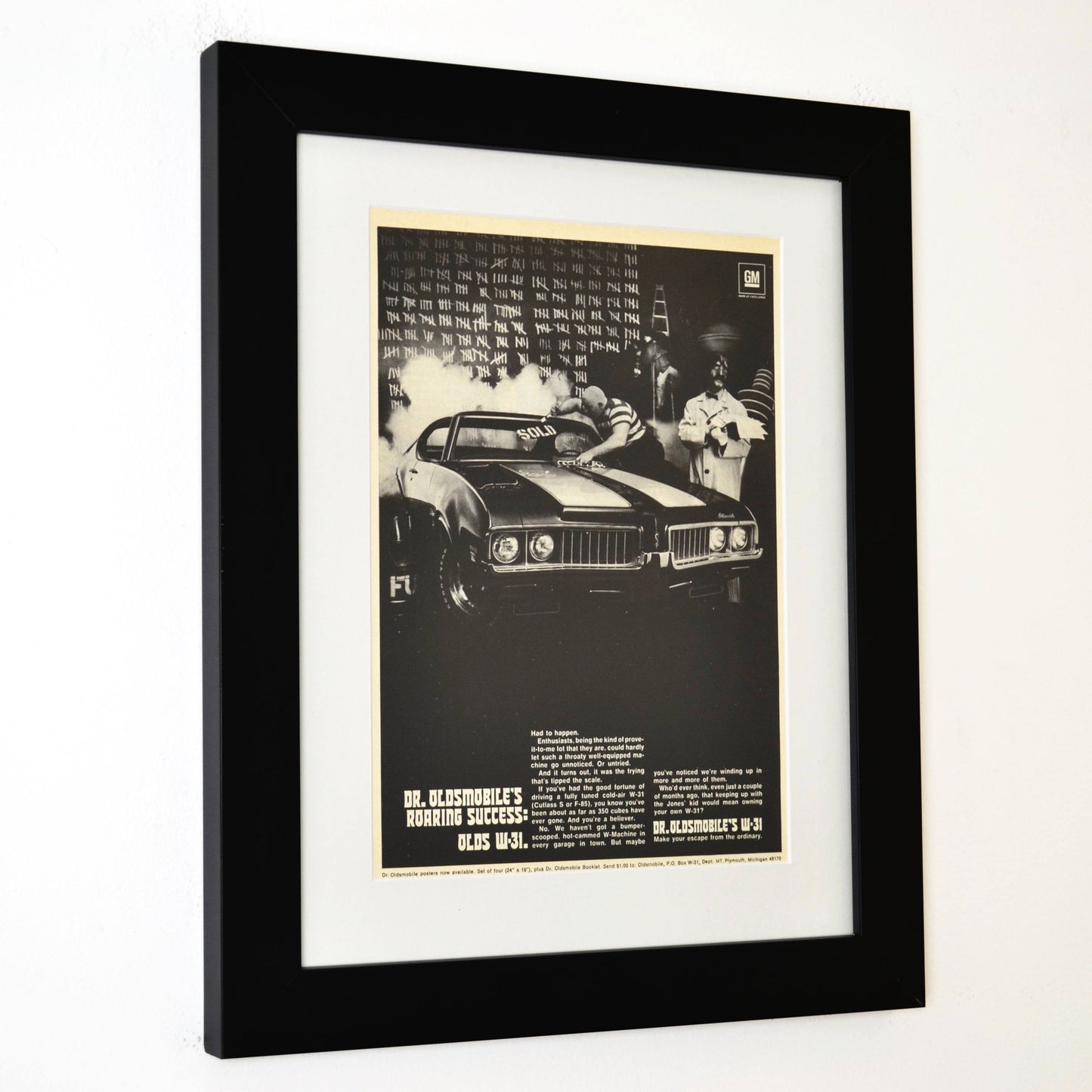 Framed 1969 Oldsmobile W-31 ad featuring Dr. Oldsmobile and burnout scene from the “Roaring Success” campaign side view
