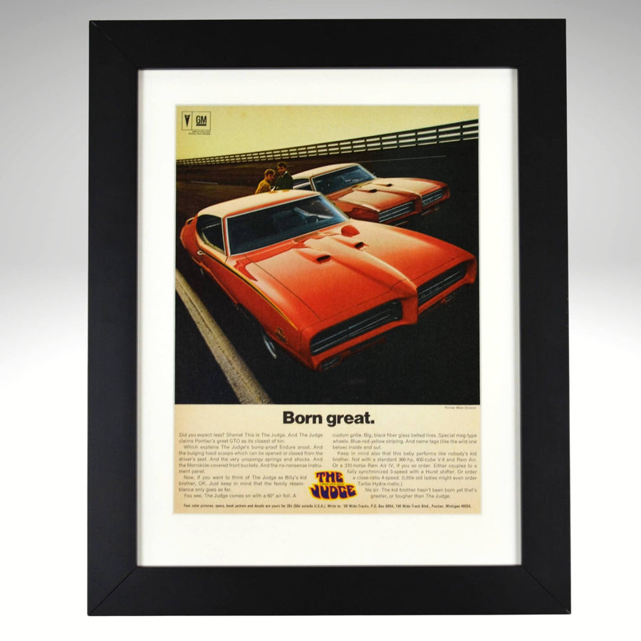 Framed 1969 Pontiac GTO Judge vintage print ad featuring two Carousel Red GTOs with headline “Born Great.” Displayed in a matte black frame with white mat — classic muscle car wall art for collectors and enthusiasts.