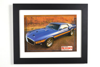 Framed 1969 Shelby GT-350 vintage print ad, featuring the bold blue Mustang with gold stripes, an iconic muscle car perfect for collectors and Ford fans.