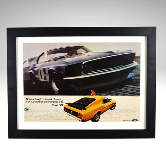 Framed 1969 Ford Boss 302 Mustang print ad highlighting Ford’s Trans-Am racing connection and the iconic muscle car’s street and track performance.