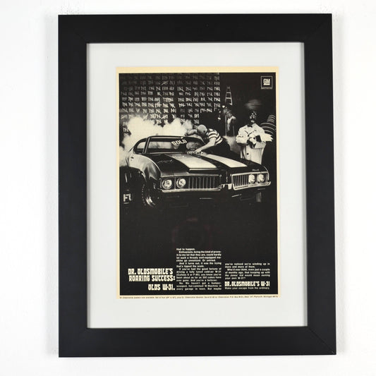Framed 1969 Oldsmobile W-31 ad featuring Dr. Oldsmobile and burnout scene from the “Roaring Success” campaign