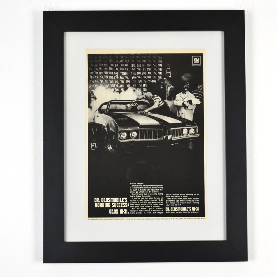 Framed 1969 Oldsmobile W-31 ad featuring Dr. Oldsmobile and burnout scene from the “Roaring Success” campaign