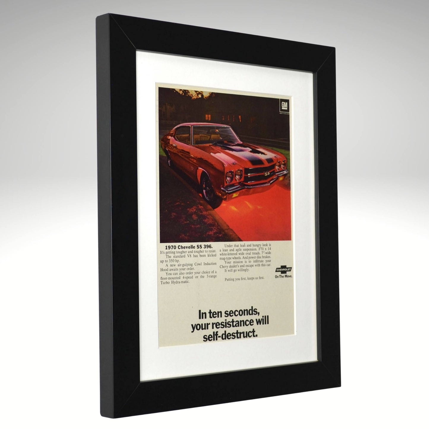 Framed 1970 Chevrolet Chevelle SS 396 print ad – red muscle car with black stripes and bold headline about resistance.