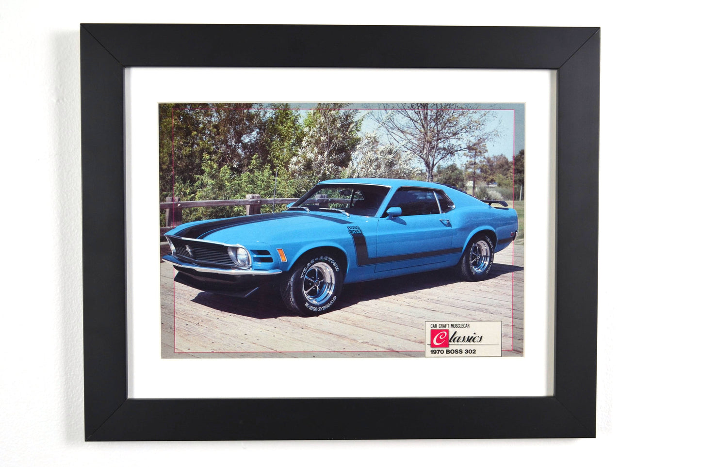 Framed 1970 Boss 302 Mustang vintage print, featuring the Grabber Blue muscle car with black graphics, perfect for collectors and Ford fans