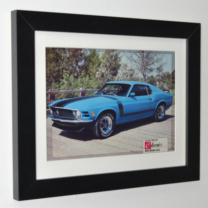 Framed side view of 1970 Boss 302 Mustang vintage print, featuring the Grabber Blue muscle car with black graphics, perfect for collectors and Ford fans