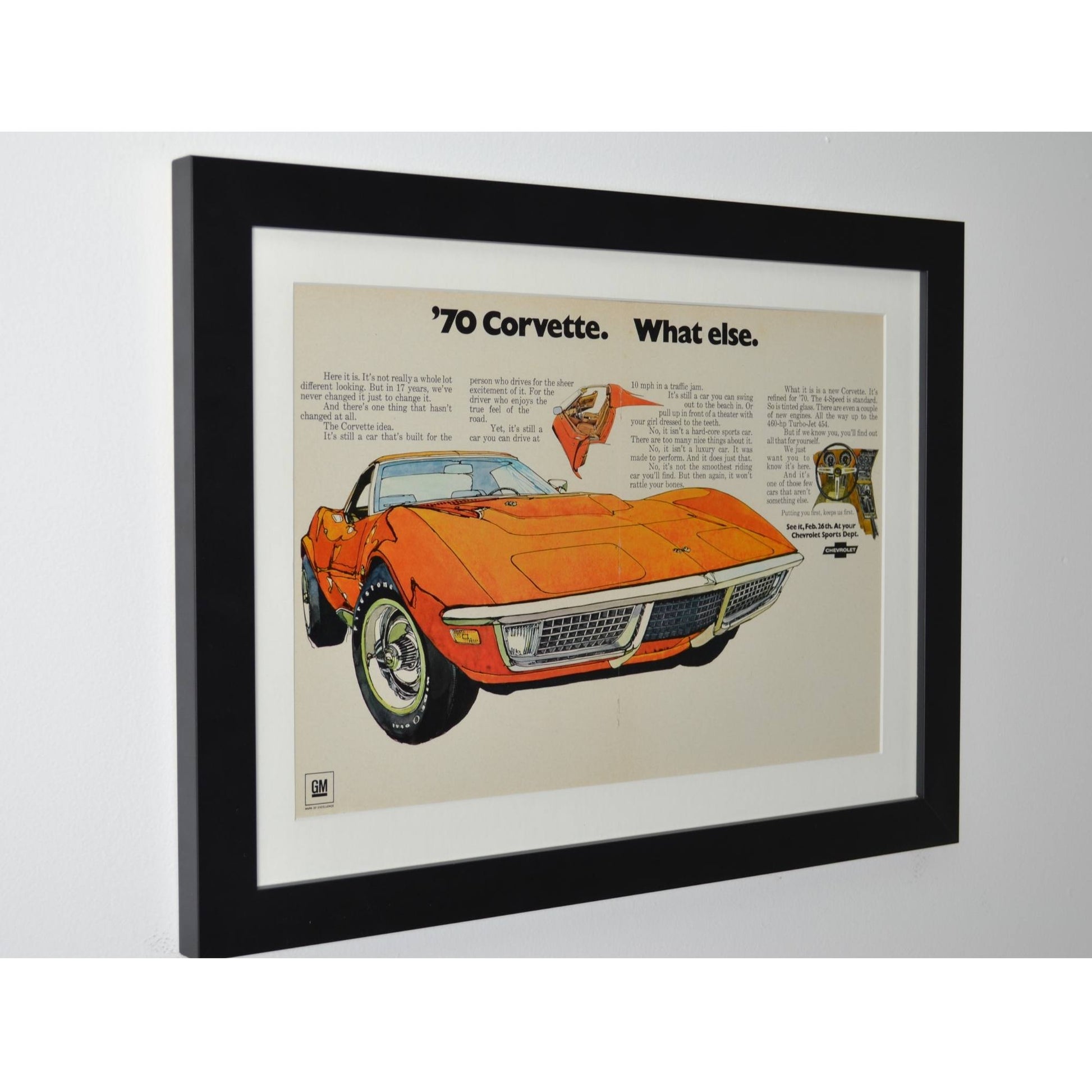 side vie of orange 1970 Chevrolet Corvette framed vintage print ad showcasing the C3 sports car’s styling, pop-up headlights, and American muscle heritage.