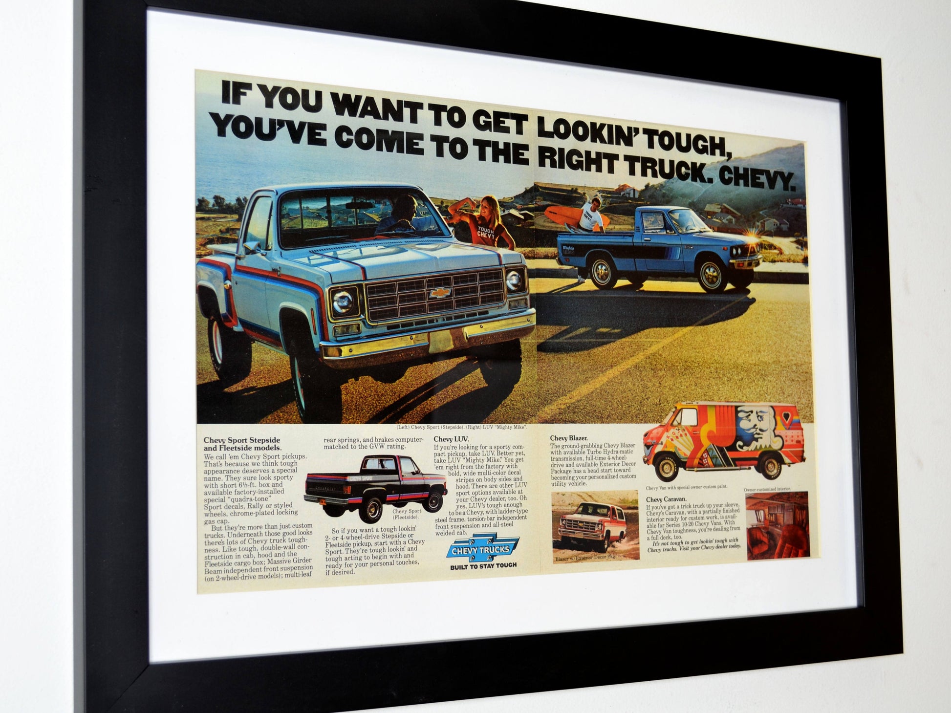 Framed 1977 Chevrolet truck ad print featuring Squarebody, LUV pickup, Blazer, and custom van with colorful 70s styling side view