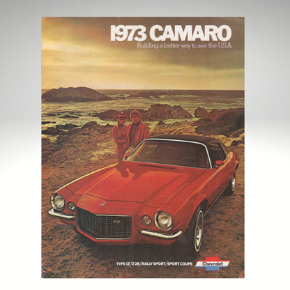 1973 Camaro advertisement with two people standing next to a red car in a scenic setting.