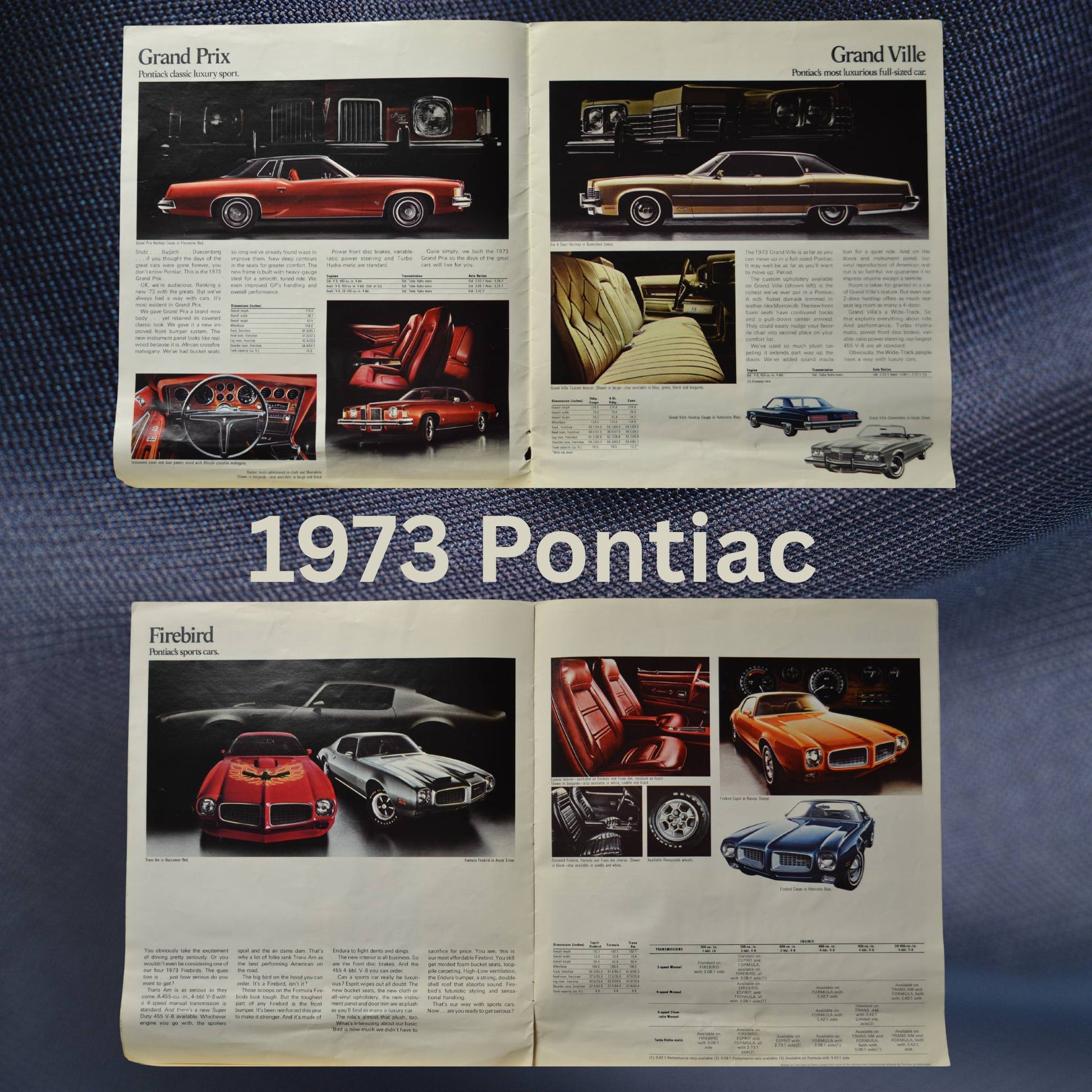 Interior pages of the 1973 Pontiac dealer brochure, showcasing Grand Prix, Grand Ville, Firebird, and other Pontiac models with specifications, features, and classic design details. Vintage automotive memorabilia.