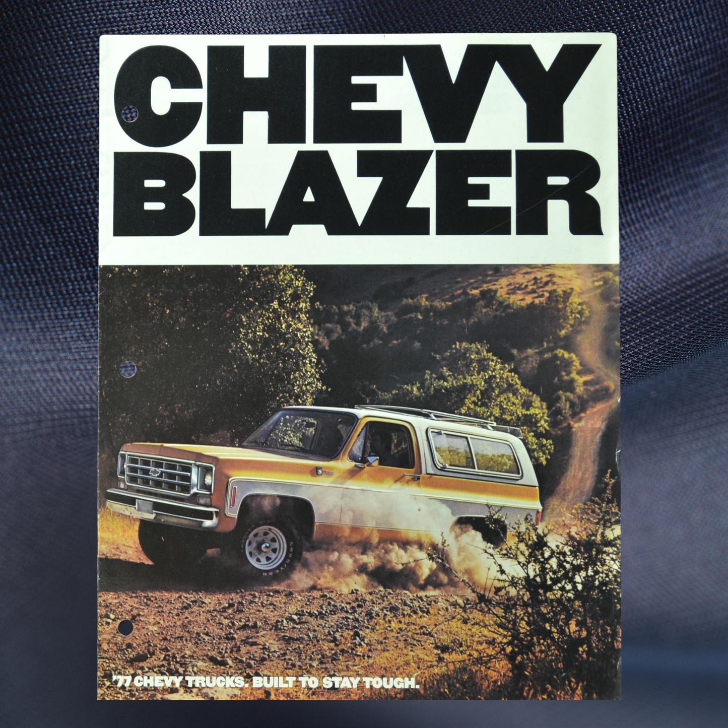 Cover of the 1977 Chevy Blazer dealer sales brochure featuring a yellow Blazer on a rugged trail.