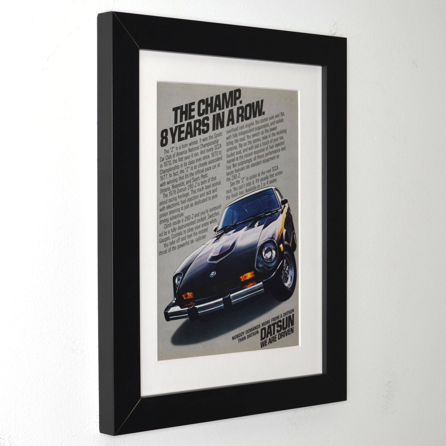 Framed poster of a 1978-datsun-280z with text on a white background