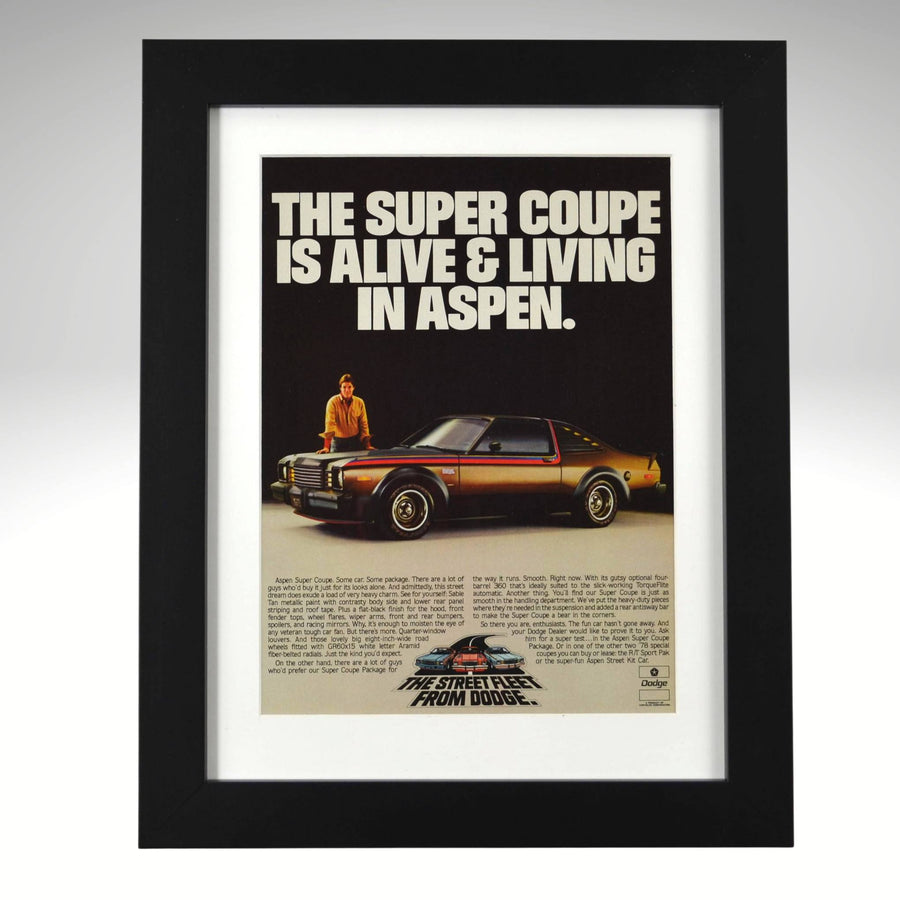 Framed advertisement for a Dodge super coupe with text 'The super coupe is alive & living in Aspen.'