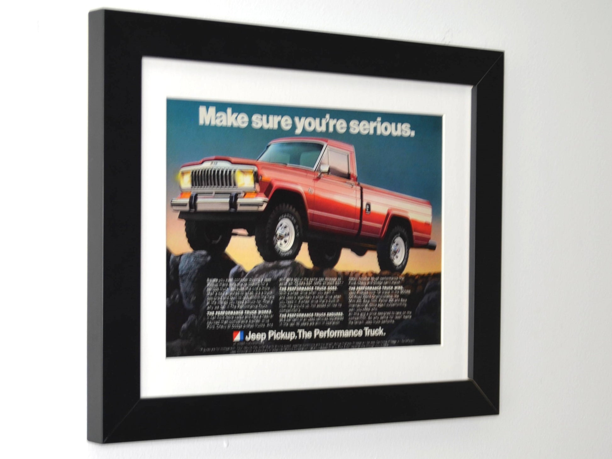 Framed 1979 Jeep Pickup truck print ad with red 4x4 on rocks – vintage Jeep wall art with new frame, mat, and glass side view