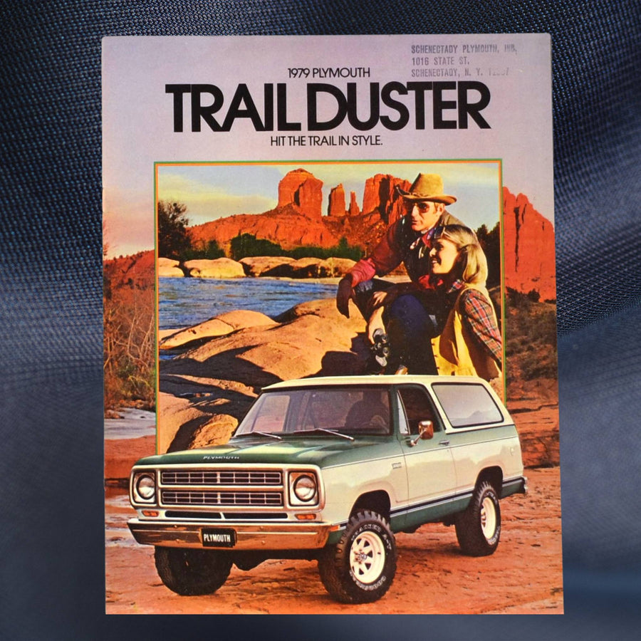 1979 Plymouth Trail Duster brochure front cover with green SUV at river’s edge