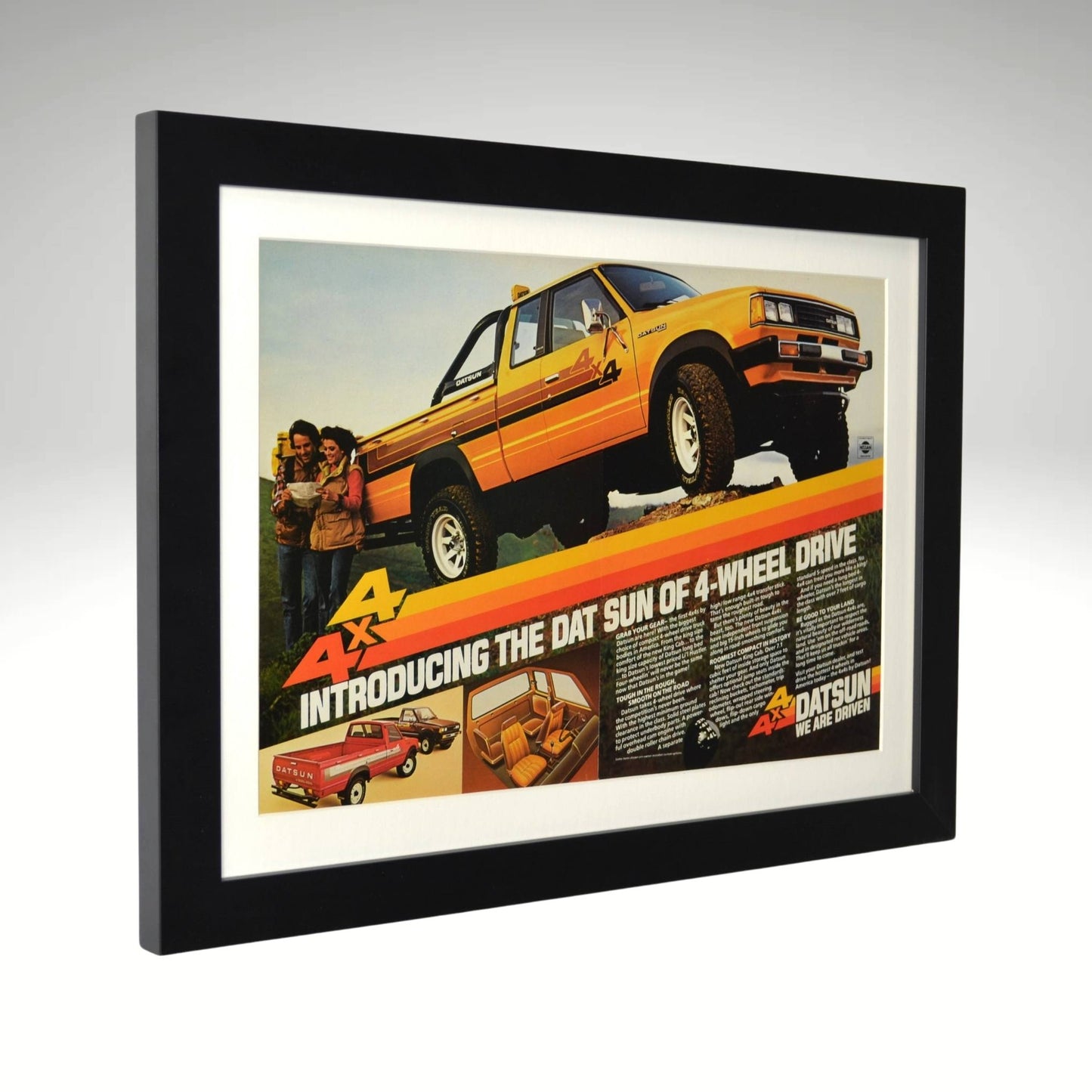 side view of yellow 1980 Datsun 4x4 framed print ad featuring Nissan’s first factory 4-wheel-drive pickup, with bold graphics and a rugged off-road stance.