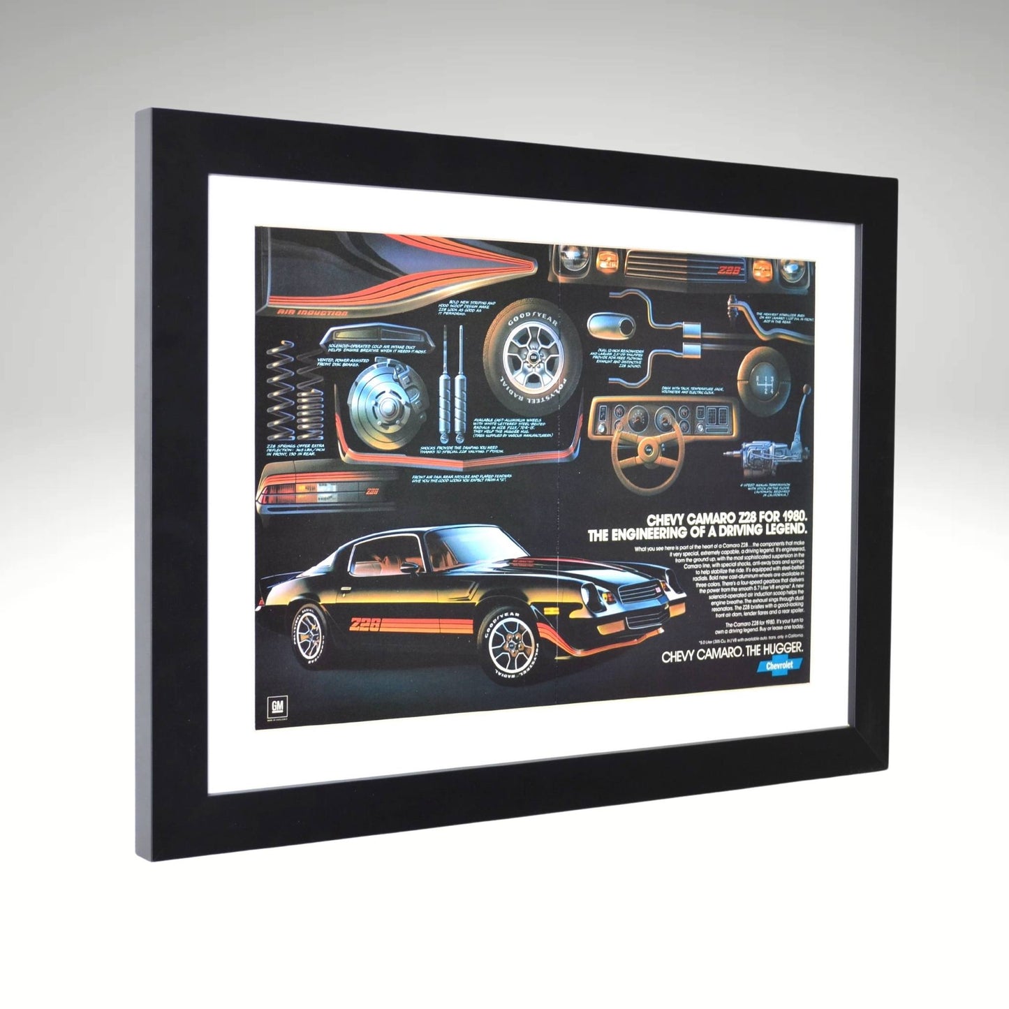 Side view of black 1980 Chevy Camaro Z28 framed vintage print ad featuring technical breakdowns of performance, handling, and classic muscle car styling.