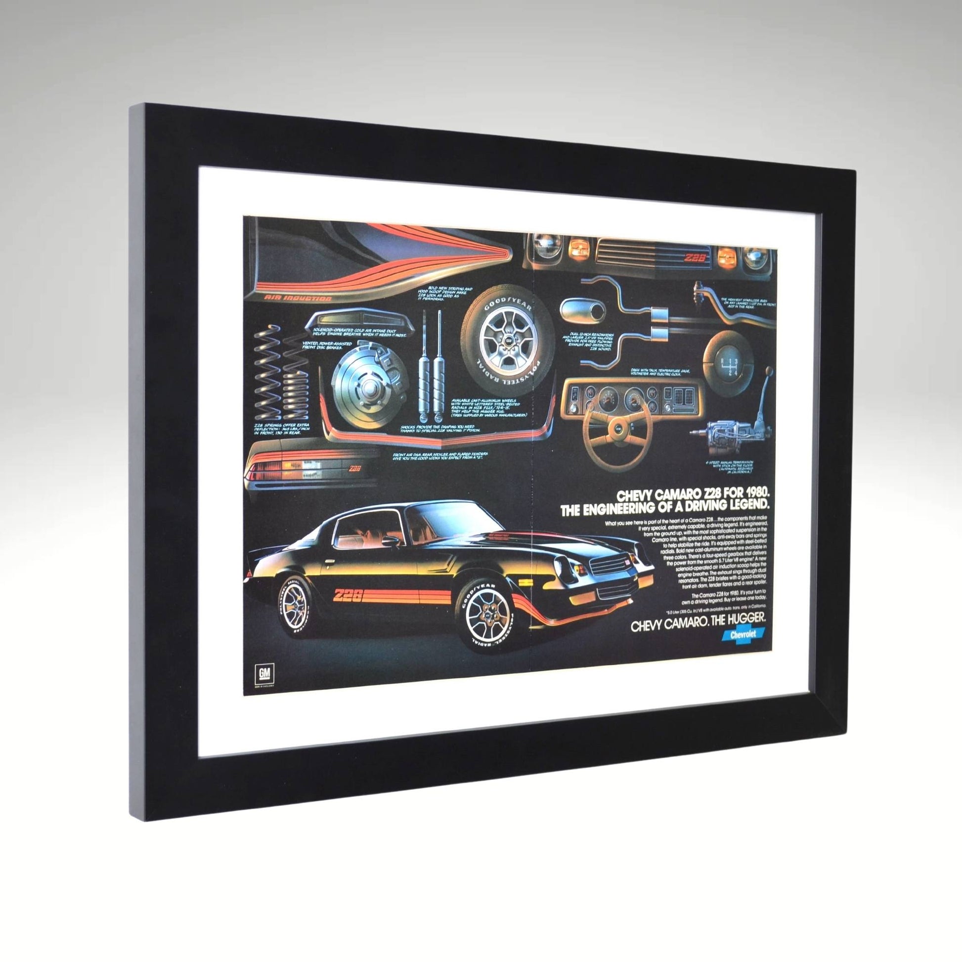 Side view of black 1980 Chevy Camaro Z28 framed vintage print ad featuring technical breakdowns of performance, handling, and classic muscle car styling.