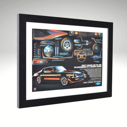 Side view of black 1980 Chevy Camaro Z28 framed vintage print ad featuring technical breakdowns of performance, handling, and classic muscle car styling.