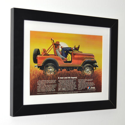 Framed side view of 1981 Jeep CJ-7 Laredo vintage print ad, featuring a cowboy relaxing on the hood of a bronze Laredo Jeep, highlighting its classic off-road style and rugged capability. A perfect retro automotive poster for Jeep lovers.