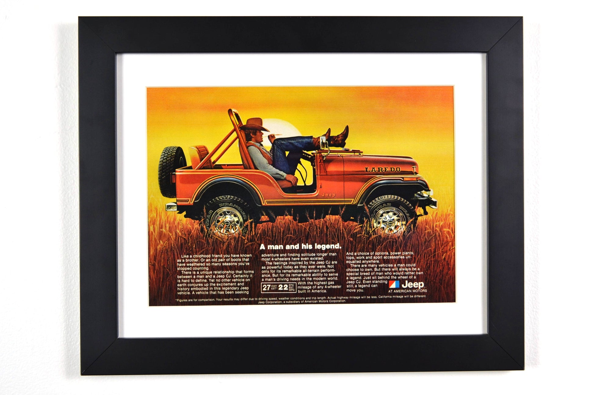 Framed 1981 Jeep CJ-7 Laredo vintage print ad, featuring a cowboy relaxing on the hood of a bronze Laredo Jeep, highlighting its classic off-road style and rugged capability. A perfect retro automotive poster for Jeep lovers.