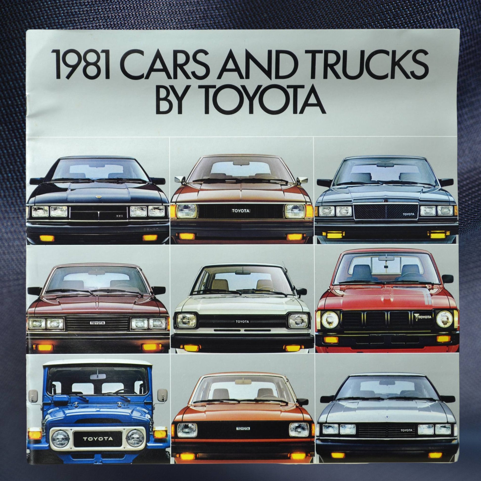 Front cover of the 1981 Toyota Cars and Trucks brochure featuring a grid layout of iconic Toyota models, including Celica, Land Cruiser, and Corolla, with sleek front-facing profiles.