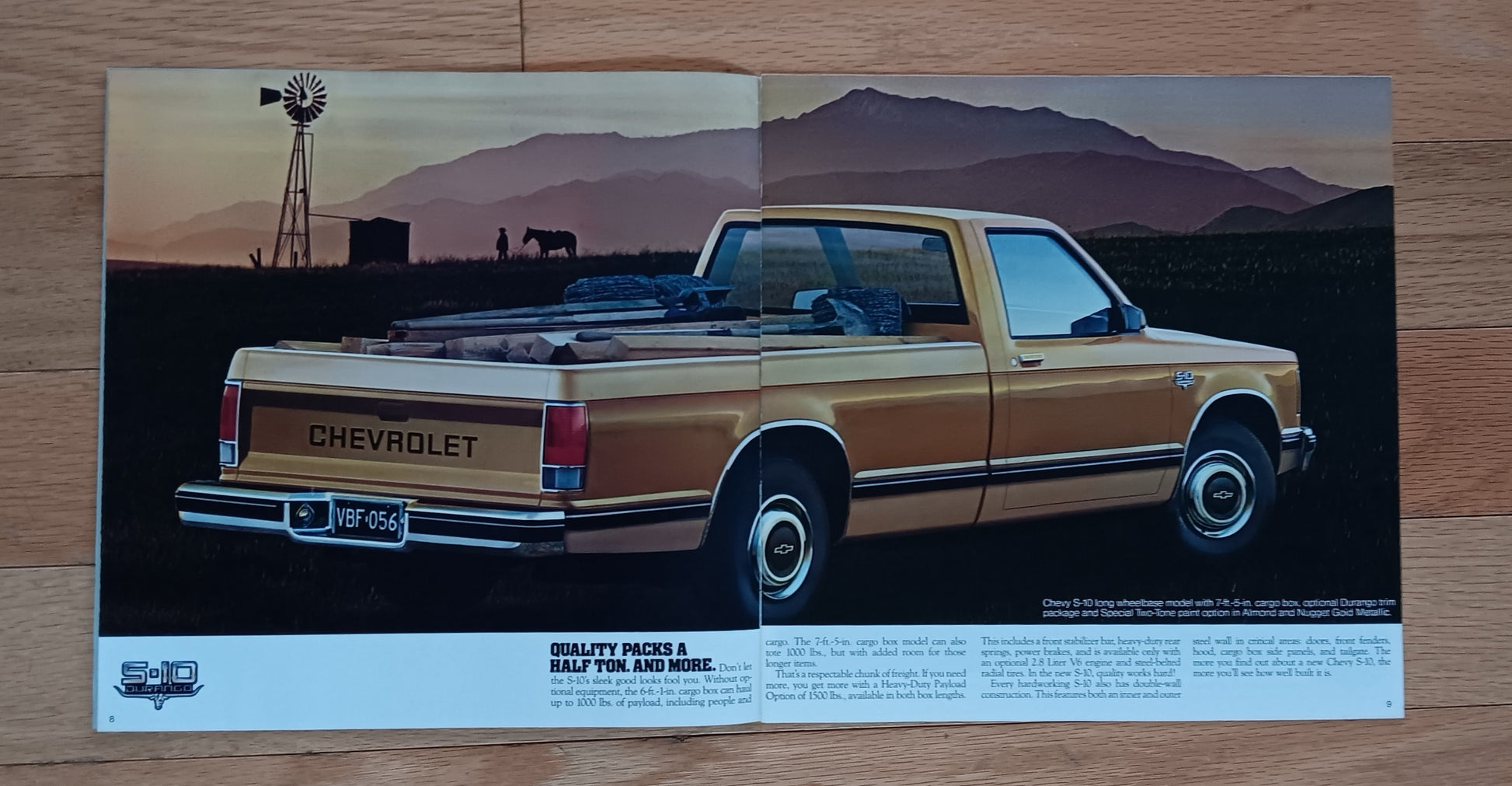 Vintage Chevrolet truck poster with a scenic background on a wooden surface