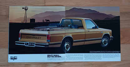 Vintage Chevrolet truck poster with a scenic background on a wooden surface