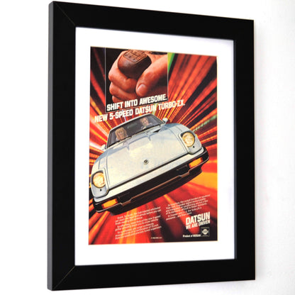 Framed 1982-datsun-280zx-turbo advertisement with a car and hand shifting gears on a white background