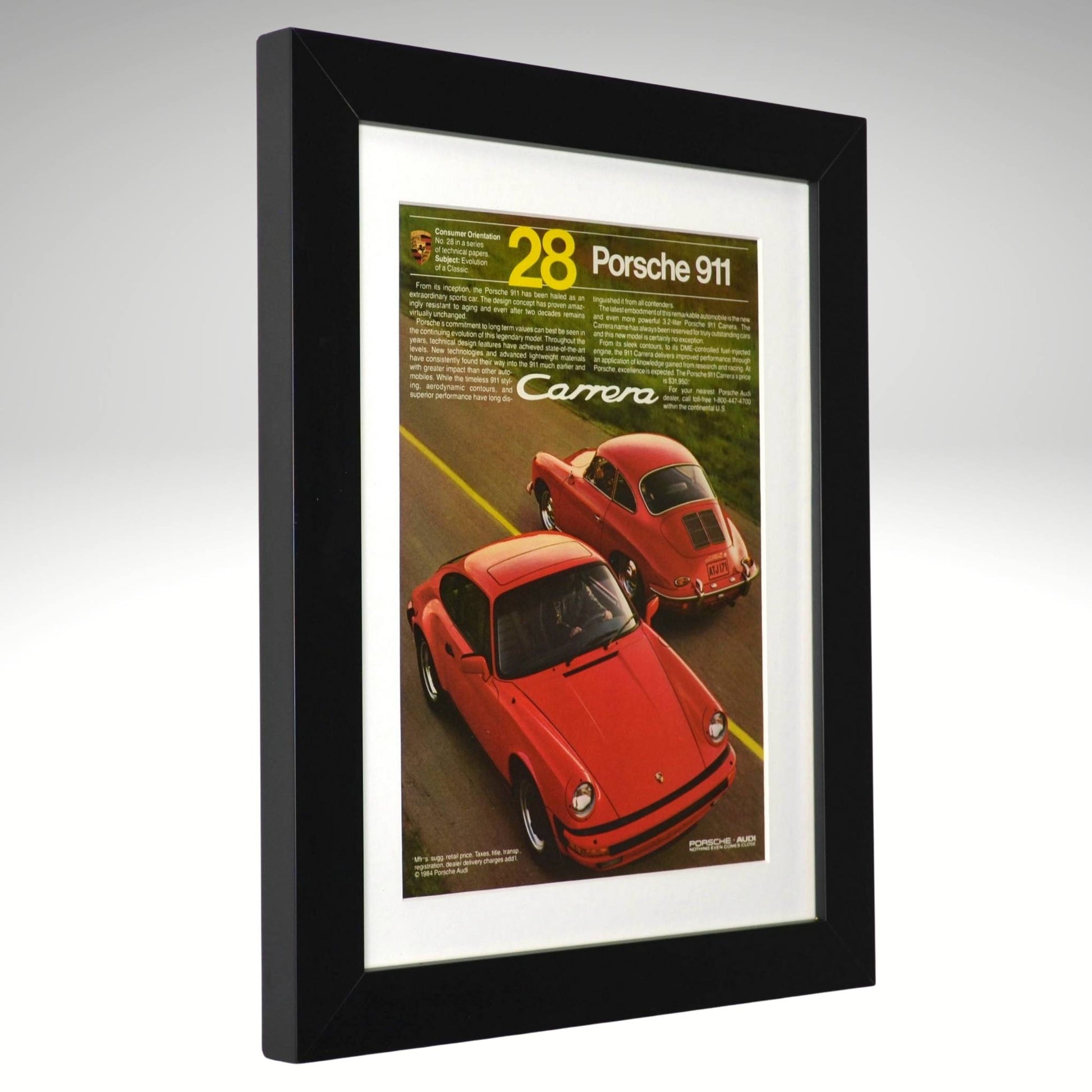 Framed poster of a red Porsche 911 Carrera with text on a gray background