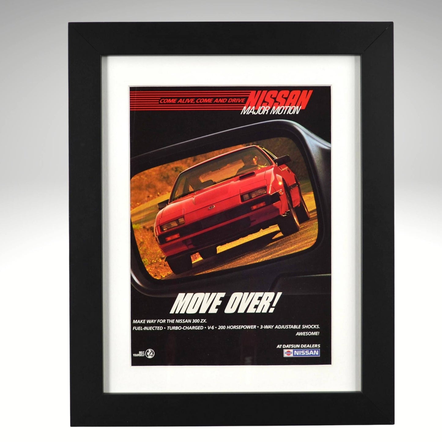 Framed 1984 Nissan 300ZX Turbo vintage print ad with “Move Over!” headline, showing the red 300ZX reflected in a rearview mirror — authentic JDM wall art for collectors and Z enthusiasts.