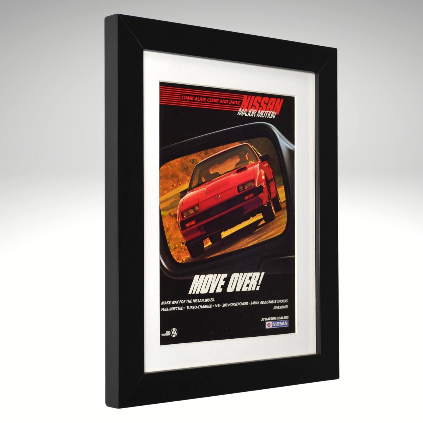 Framed 1984 Nissan 300ZX Turbo vintage print ad with “Move Over!” headline, showing the red 300ZX reflected in a rearview mirror — authentic JDM wall art for collectors and Z enthusiasts side view