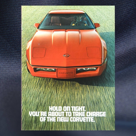 1984 Corvette ad cover – red C4 Chevy with bold “Hold On Tight” tagline from vintage magazine insert
