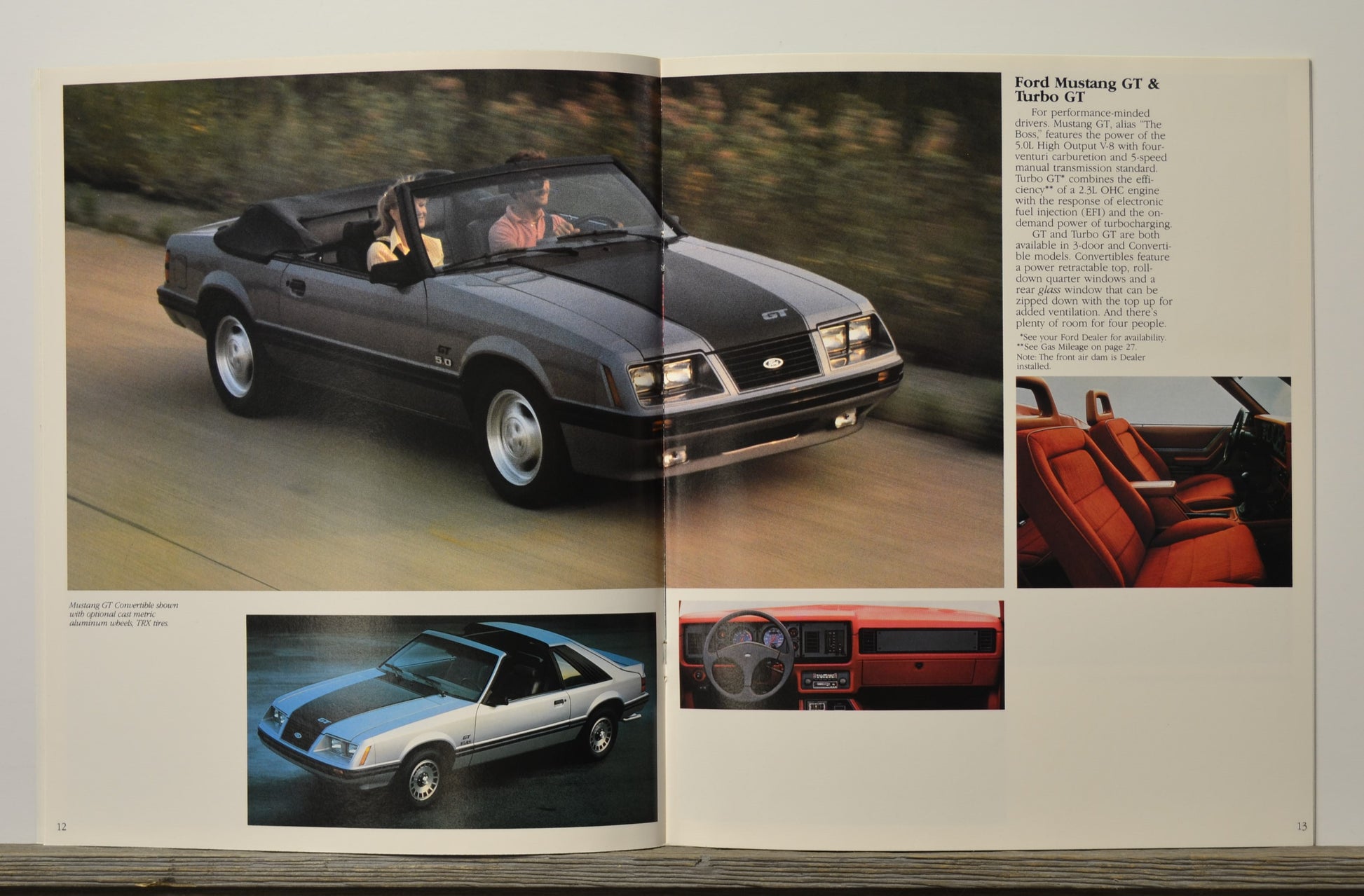 Vintage car advertisement with Ford Mustang GT & Turbo GT models on a white background.