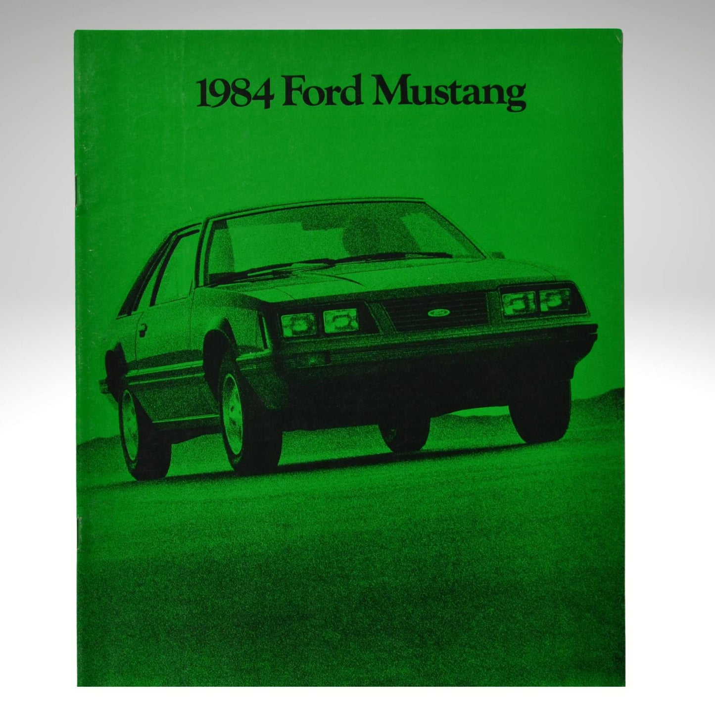 1984 Ford Mustang brochure cover with green background