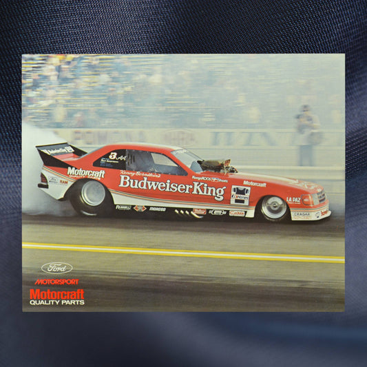 1984 NHRA hero card showing Kenny Bernstein’s Budweiser King Funny Car in action, leaving a trail of smoke as it thunders down the dragstrip