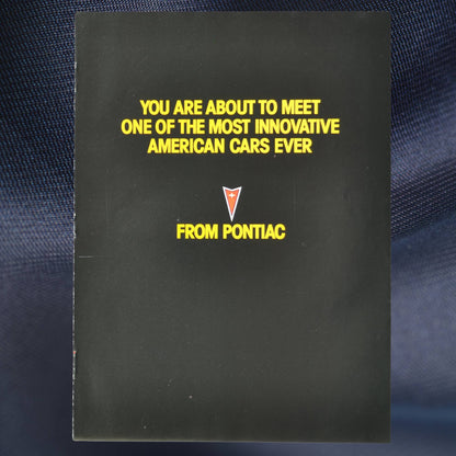 front cover with Pontiac badge and bold yellow text