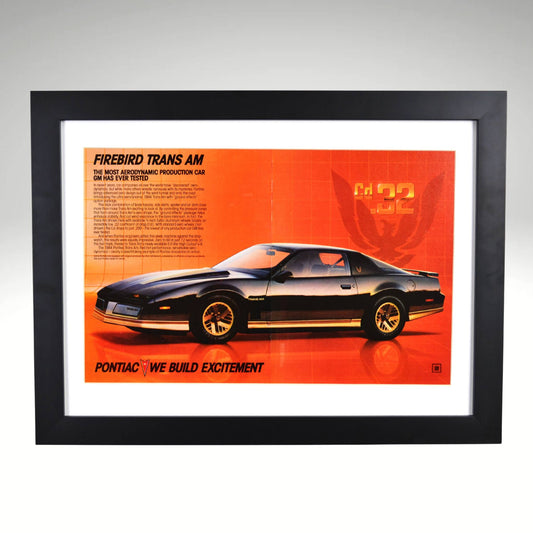 1984 Pontiac Firebird Trans Am framed print ad featuring the Cd .32 aerodynamic design, Firebird emblem, and classic 80s Pontiac styling.