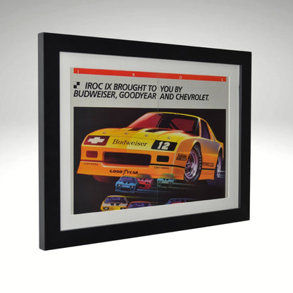 Side view of yellow 1986 Chevrolet IROC Camaro framed vintage print ad featuring the Budweiser-sponsored Z28 race car, Goodyear branding, and bold racing graphics.