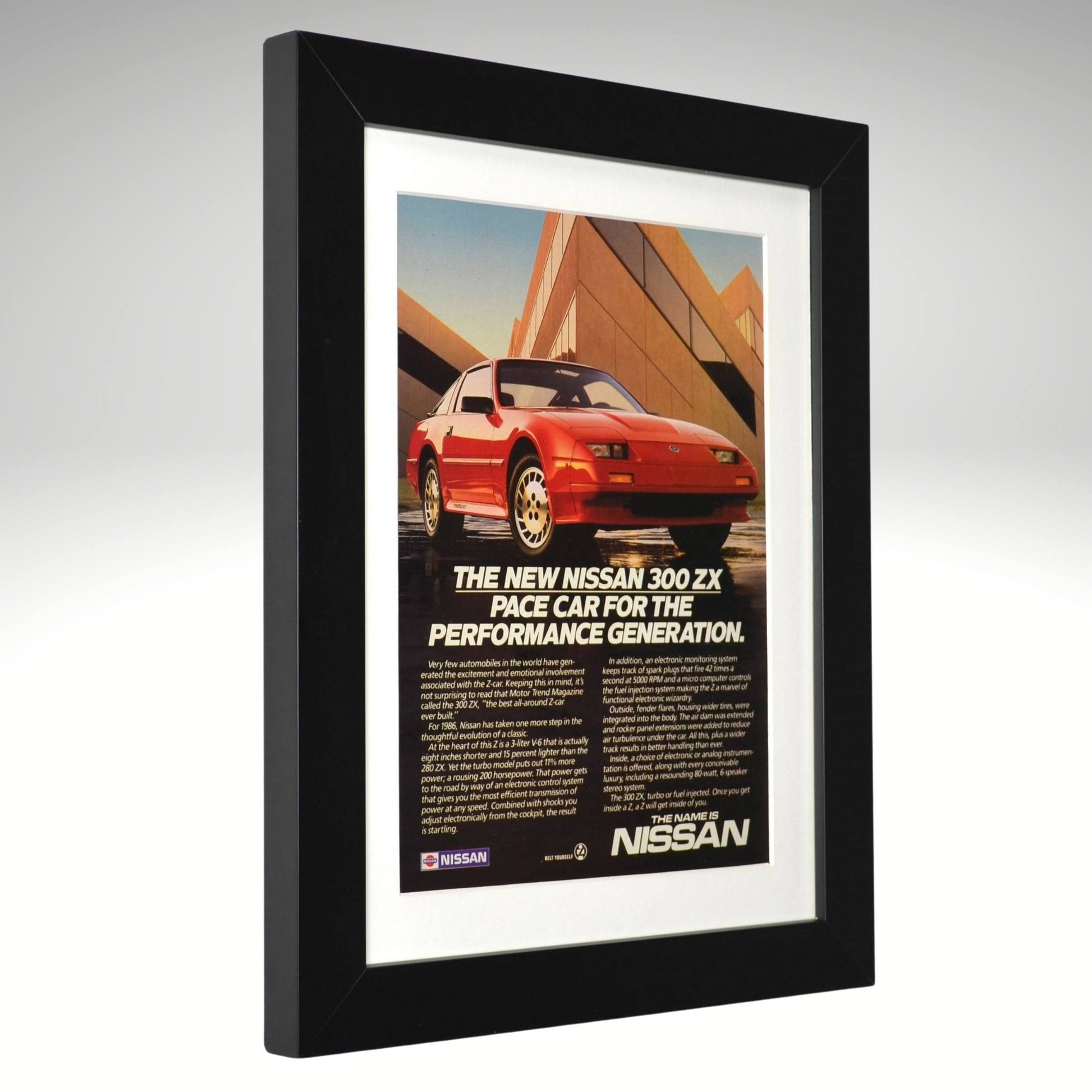 Framed 1986 Nissan 300ZX vintage print ad featuring a red 300ZX with geometric architecture and “For the Performance Generation” headline — authentic JDM wall art for collectors and enthusiasts side view