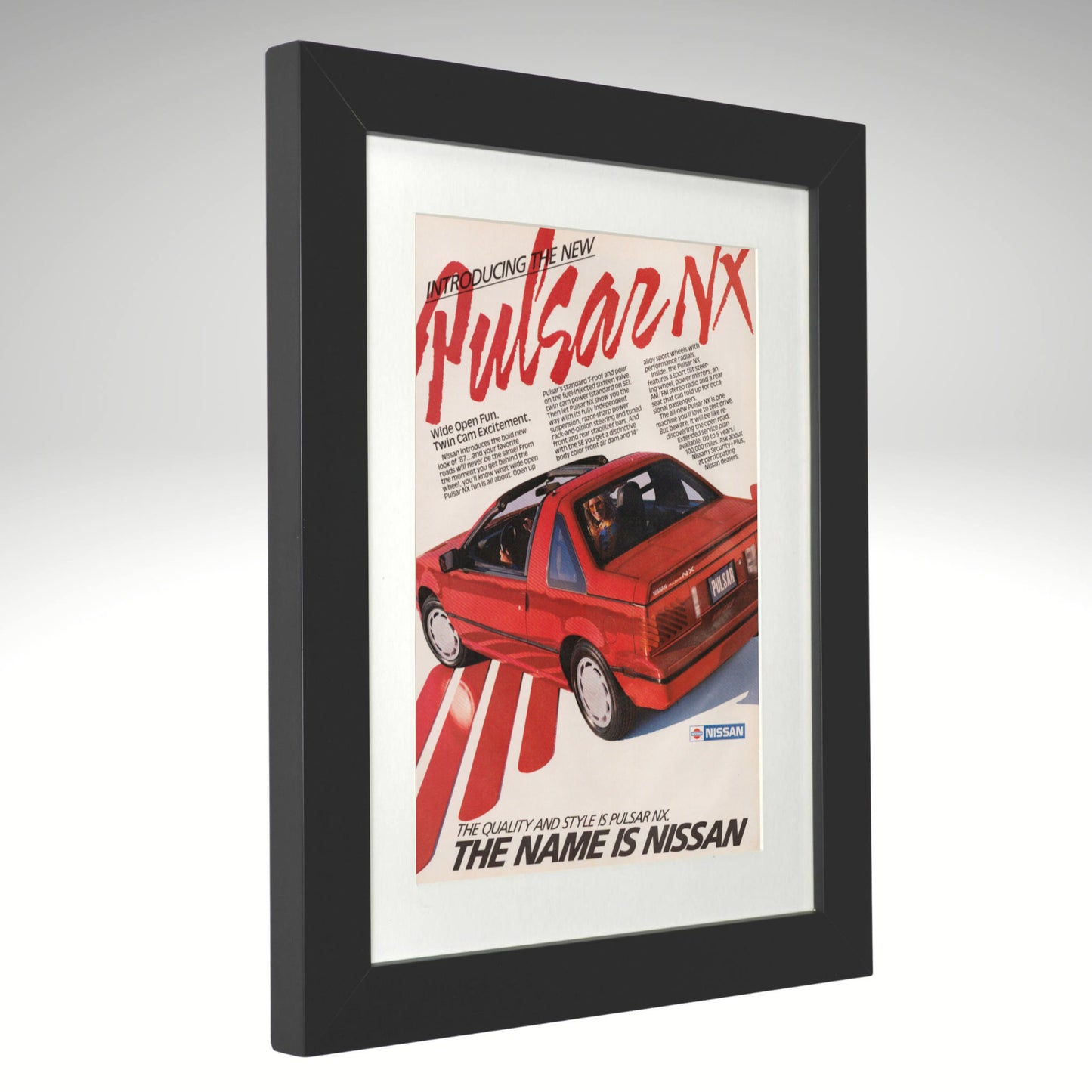 Framed Nissan Pulsar NX advertisement on a white background