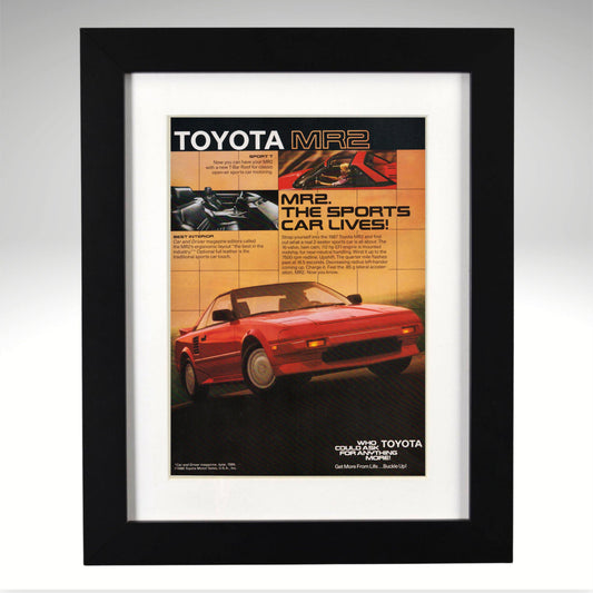 Framed Toyota MR2 advertisement with a red car on an orange background
