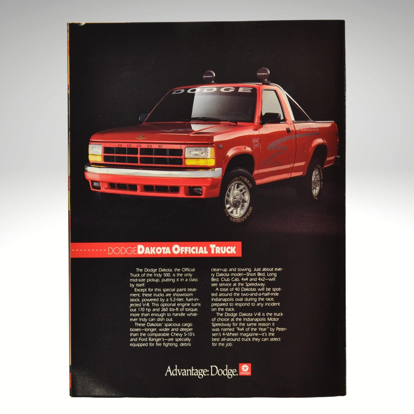 Red Dodge Dakota truck on a black background with 'Advantage Dodge' branding.