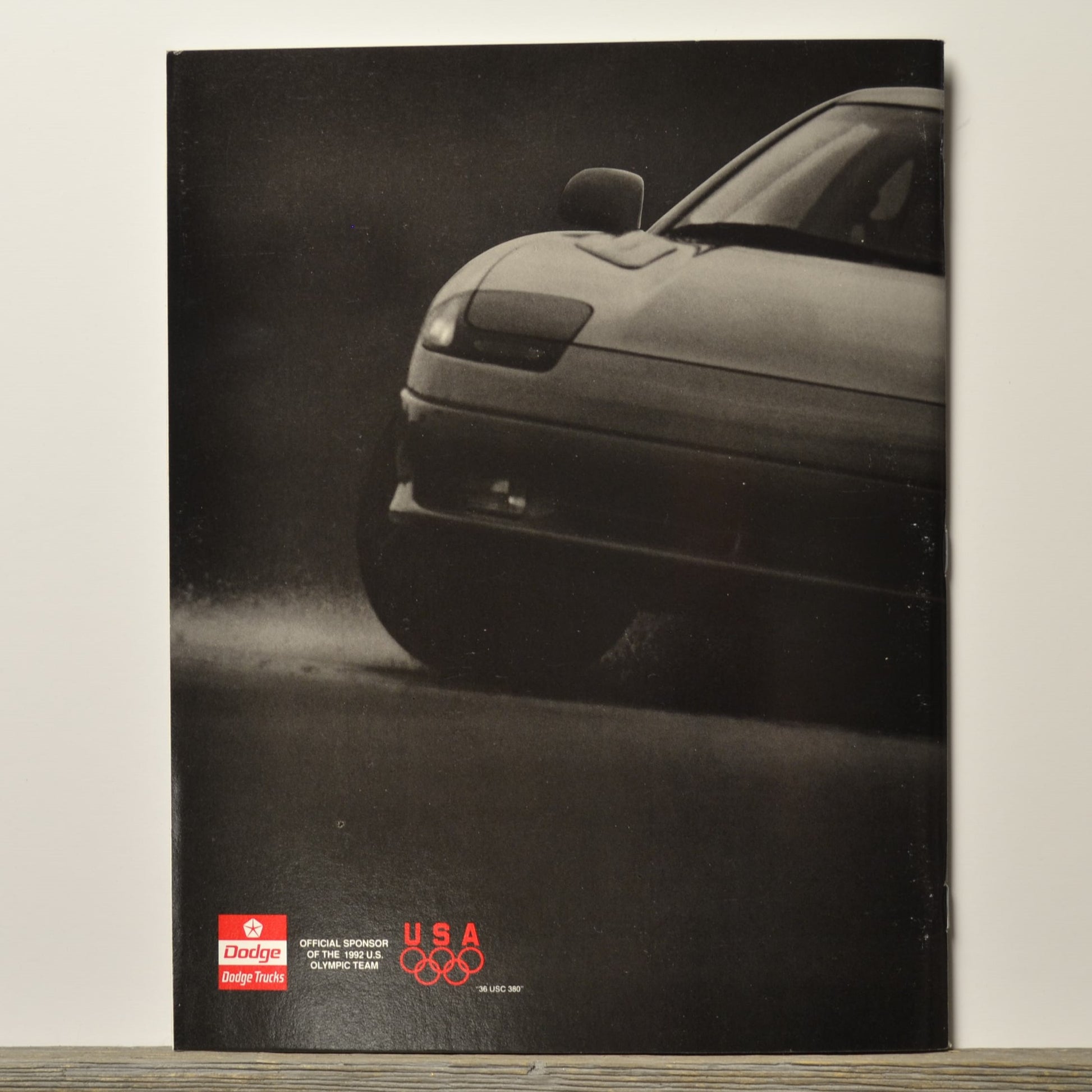 Car brochure with a car on the cover, featuring Dodge and USA Olympic logos.