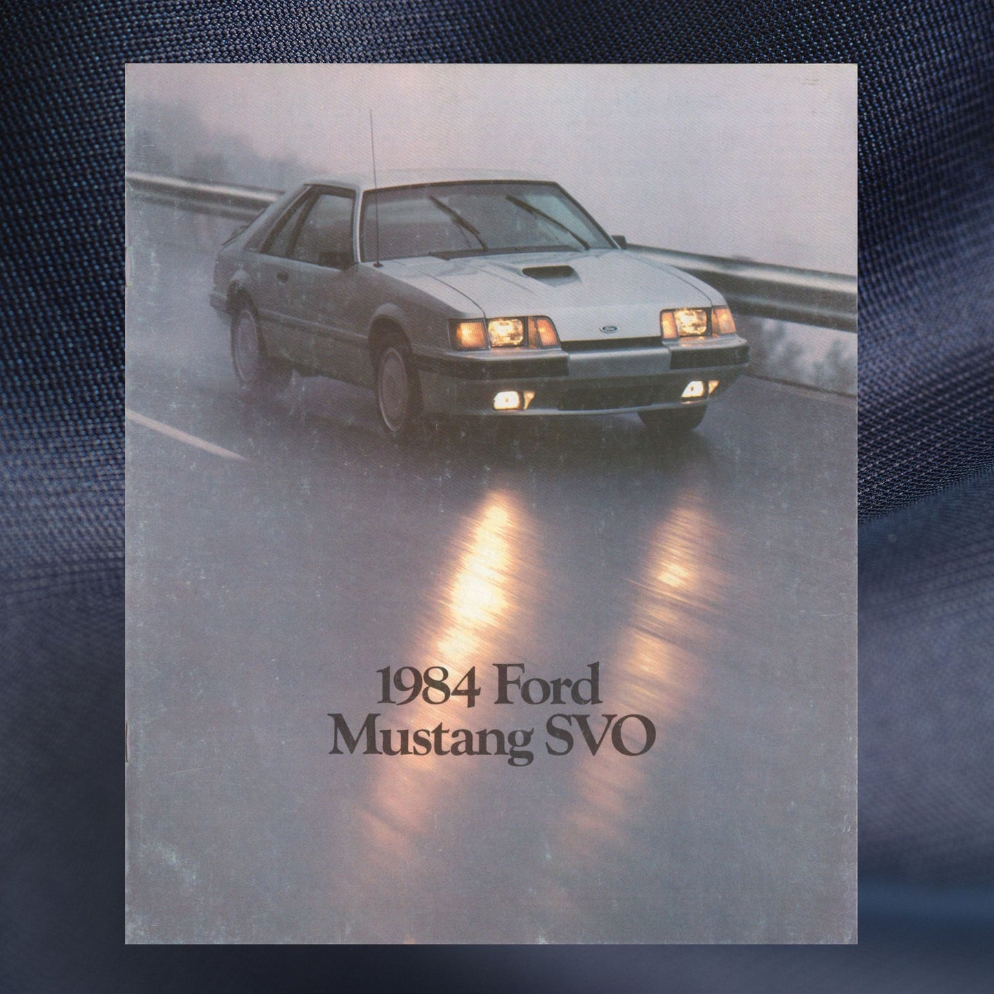 1984 Ford Mustang SVO original dealer sales brochure cover featuring the silver turbocharged Fox-body Mustang